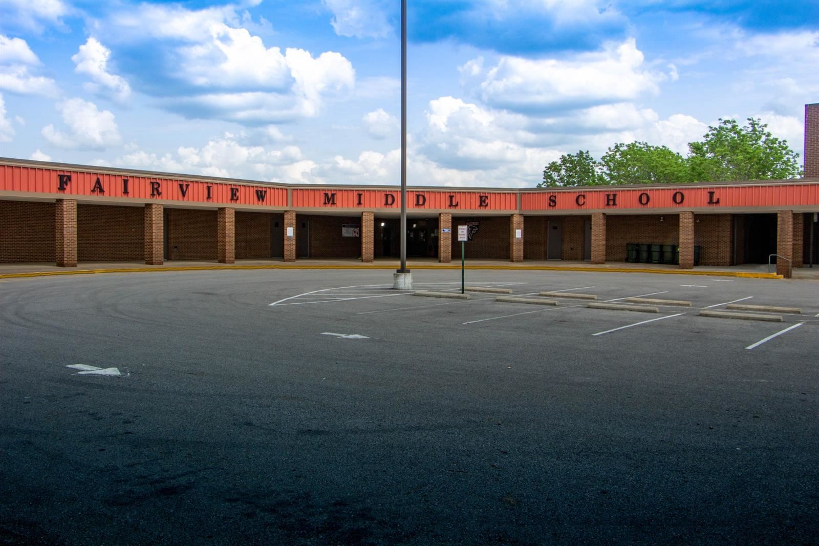 A falcon mascot stands in front of Fairview Middle School
